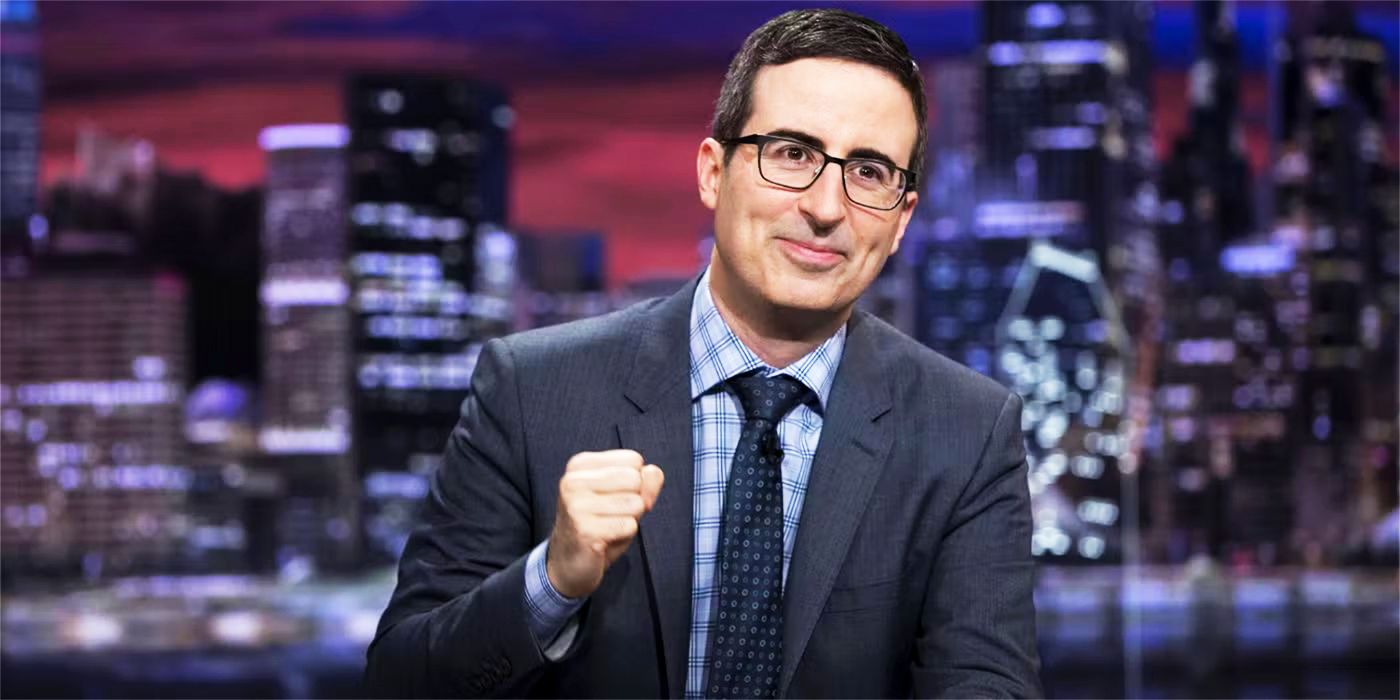 john oliver smiling in an episode of last week tonight fz