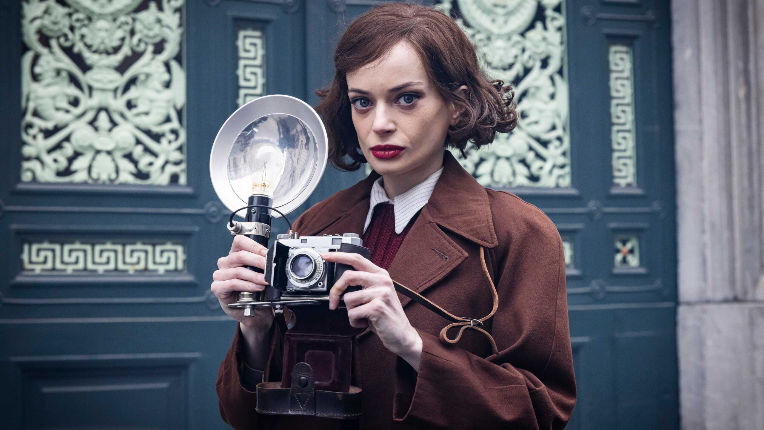 ruth codd holding a vintage camera in bookish season 2 scaled 1