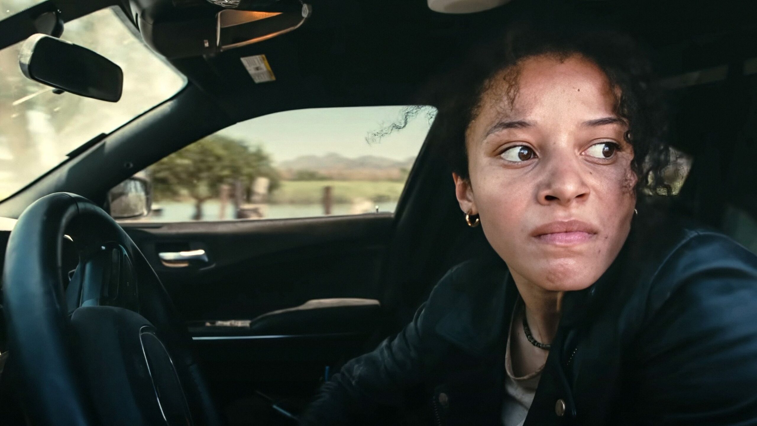 willa looking angry as she turns her car around in one battle after another scaled